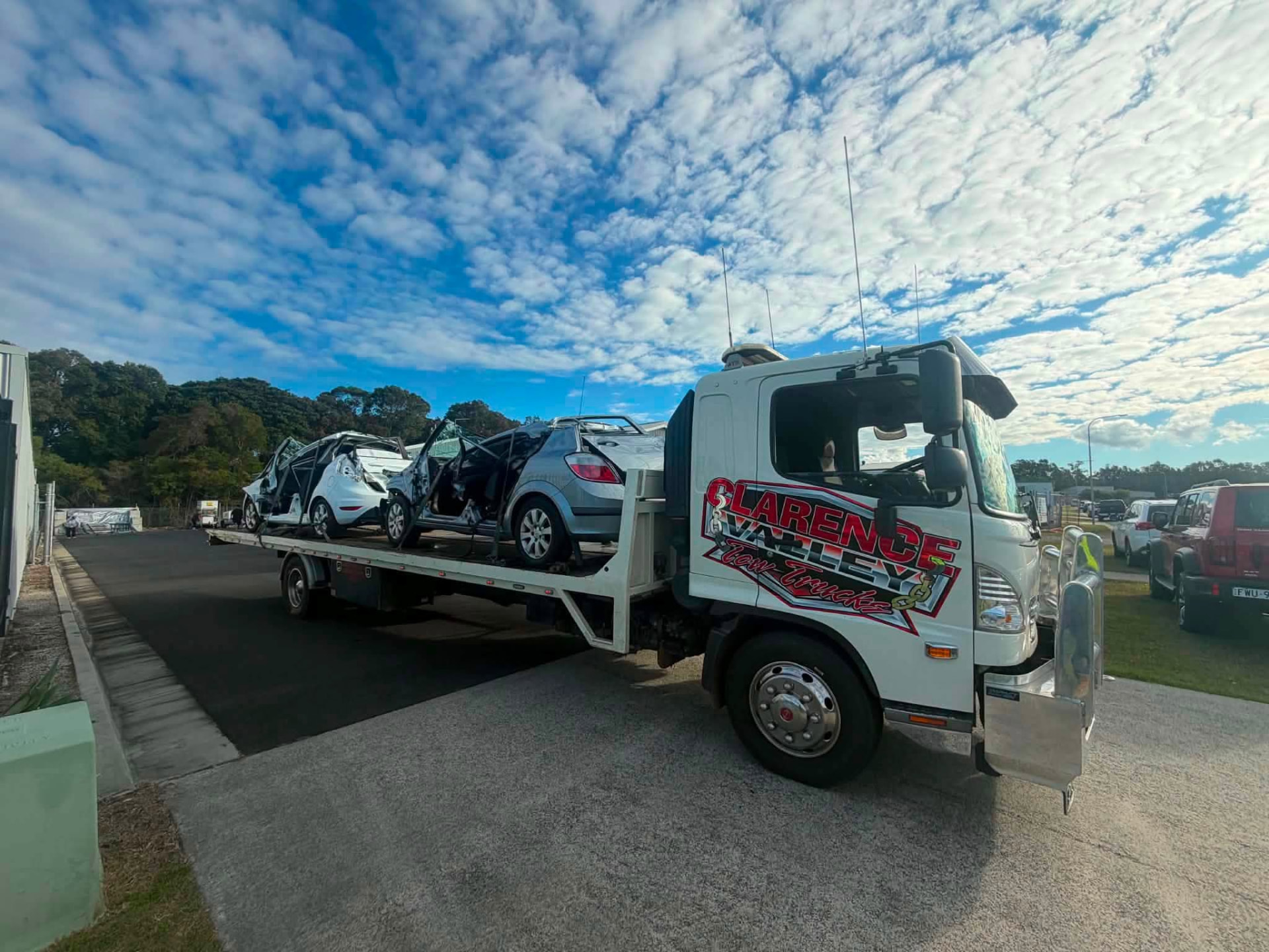 Clarence Valley Tow Trucks flatbed loaded with two vehicles on a local tow job